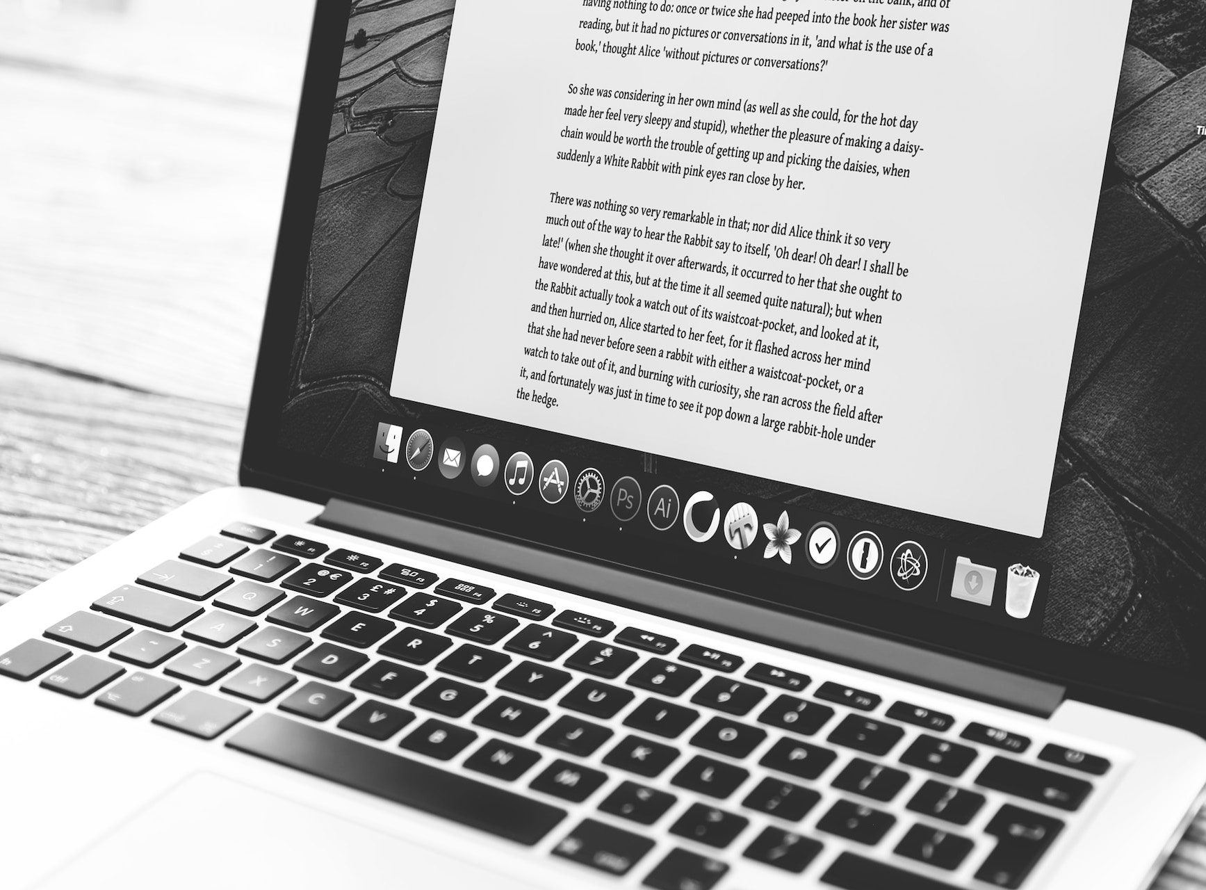 Laptop with open text editor on screen, writing in progress